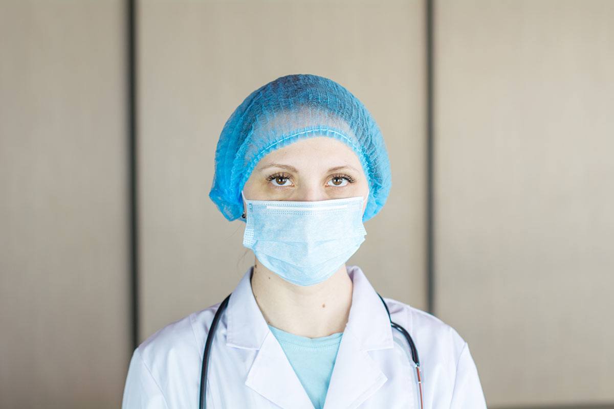 health-worker wearing mask and hair net