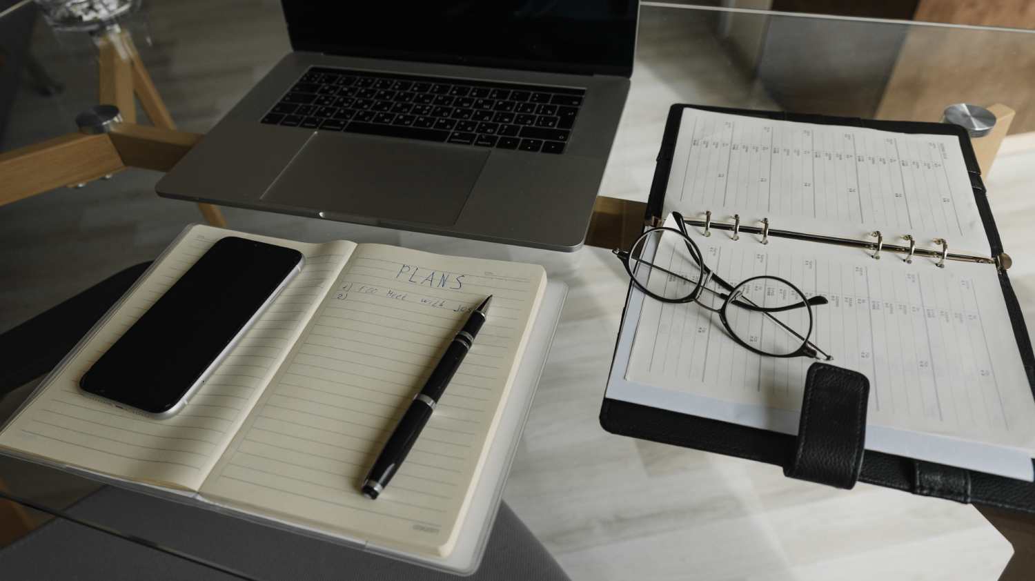 Laptop, Diary & Pen kept on Table